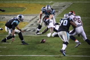 DeMarcus Ware (94) lunges for a fumbled ball as Cam Newton (1) looks on. The fumbled helped squashed what little hope was left of a late Panthers comeback