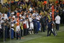 Peyton Manning (18) and Clancy Barone, offensive line coach, embrace on the sidelines in the final minutes of the game knowing they had cemented their victory