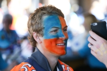 A Broncos fan checks out his face paint prior to the game